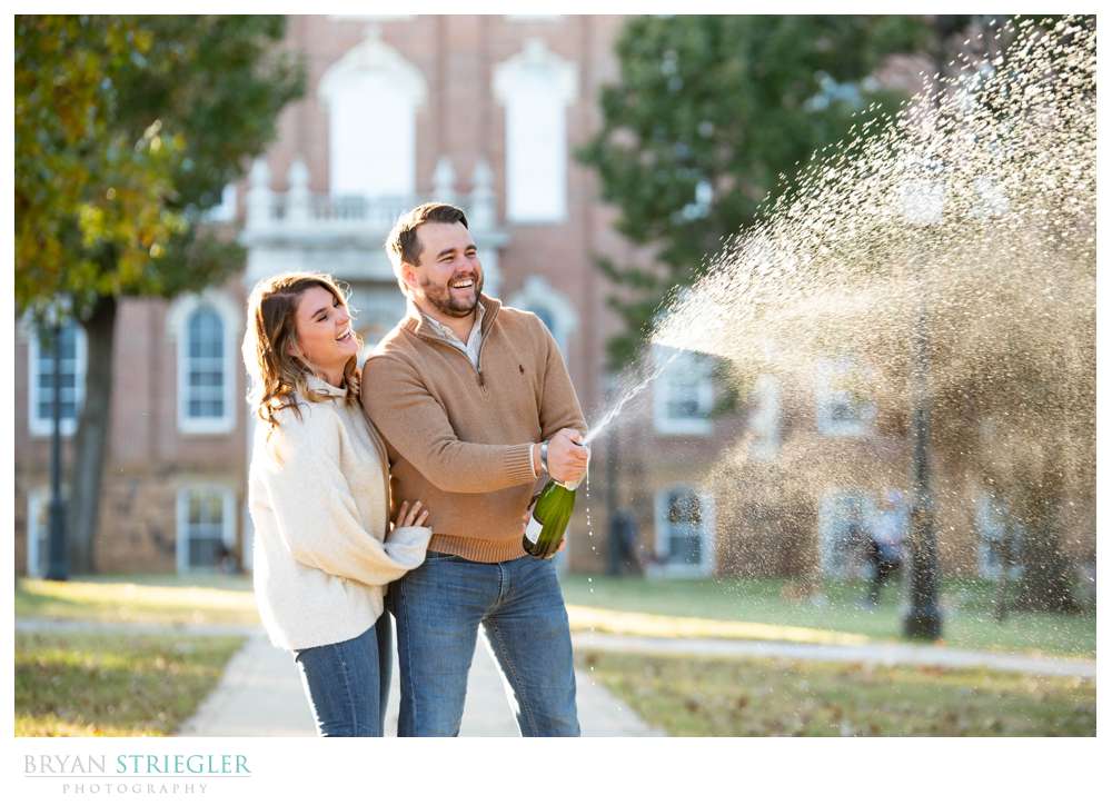 opening champagne engagement photo